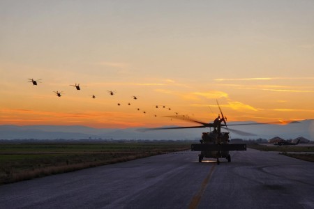 U.S. Army Soldiers from the 3rd Battalion, 6th Cavalry, Combat Aviation Brigade, 1st Armored Division — operationally controlled by the 1st Infantry Division — and soldiers of the Hellenic Army participate in a 26 aircraft elephant walk at Camp Perissaki, Greece, during a visit from Lt. Gen. Angelos Choudeloudis, 1st Hellenic Army commanding general, Dec. 27, 2022. 