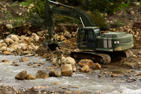 U.S. Army Pfc. Levi Walkup of the California Army National Guard’s 649th Engineer Company, 185th Military Police Battalion, 49th Military Police Brigade, traverses a trail of boulder he placed to shorten the route between his excavator and a mission planning area while working to reroute part of the San Ysidro Creek inside the Randall Road Debris Basin, Jan. 13, 2023, in Montecito, California, as part of the state’s storm response. The basin is in the same area where a deadly mudflow hit in 2018. The engineers are supporting the Santa Barbara County Office of Emergency Management through the California Governor&#39;s Office of Emergency Services. 