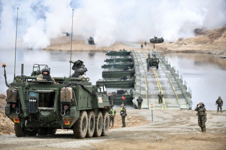 U.S. Army Soldiers assigned to 23rd Chemical Battalion, 2nd Infantry Division Sustainment Brigade, 2nd Infantry ROK-U.S. Combined Division prepare to cross an Improved Ribbon Bridge as part of a wet gap crossing on the Imjin River, South Korea during Exercise Warrior Shield on March 15, 2023. Soldiers on the opposite side of the river create a smoke screen to conceal the advancement of troops across the river. Warrior Shield is a training exercise within the 2nd Infantry Division that employs Fight Tonight fundamentals and capabilities.