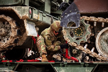 Army Sgt. Jonathan Campbell, assigned to the 51st Composite Truck Company, 18th Combat Sustainment Support Battalion, 16th Sustainment Brigade, tightens a rig for heavy equipment transportation during Orion 23 in Camp De Mailly, France, April 23, 2023. Orion 23 is a French-led interoperability exercise that is designed to develop partnerships with allies and asses the ability to operate within a coalition.