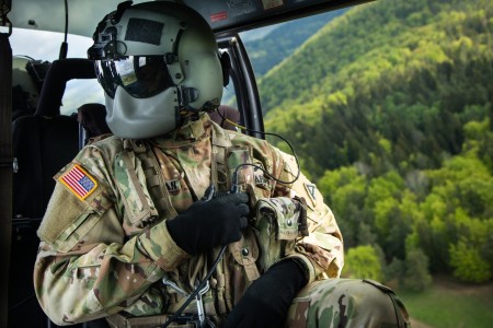 Spc. Logan Speakman, Joint Multinational Readiness Center Falcon team Crew chief, speaks over the radio with his team while inside a UH-72A Lakota during a Combined Resolve 18 in Hohenfels, Germany, May 5, 2023. Combined Resolve 18 is a U.S. Army Europe and Africa-directed combat training exercise for the U.S. Army’s 2nd Armored Brigade Combat Team, 1st Cavalry Division, as well as our NATO allies and partners.